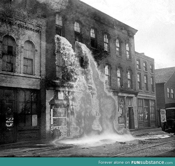 Illegal alcohol being poured out during the Prohibition. (Detroit, 1929)