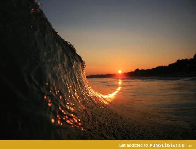 The sunset curving up a wave