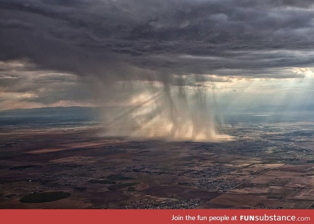 Distant storm cloud seen from airplane window