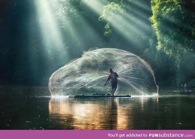 Fisherman casting his net