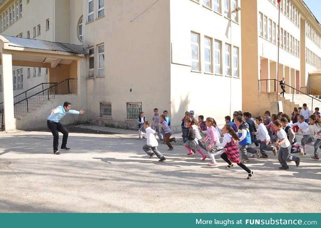 A teacher welcoming his students on the first day of school