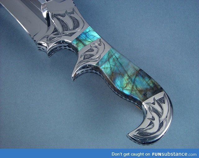 A knife with a handle made of the mineral Labradorite