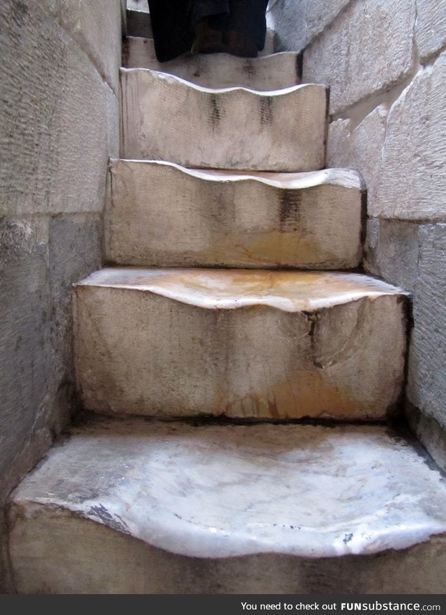 500 years of walking up the marble stairs of The Leaning Tower of Pisa