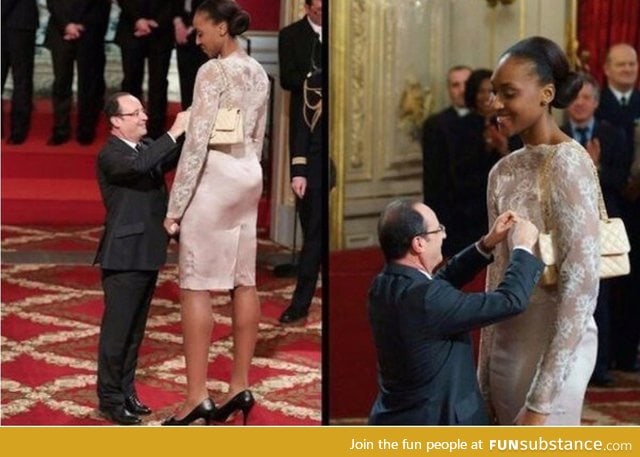 President Francois Hollande awards the basketball player Sandrine Gruda