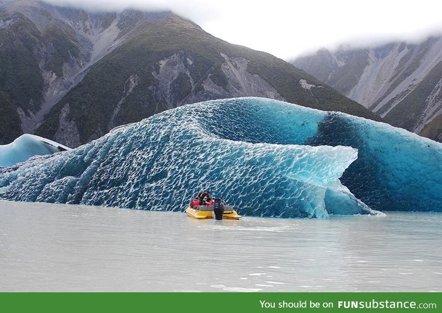 The dark blue bottom of an iceberg that just rolled over