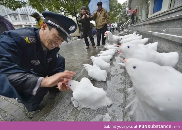 Chinese security guard has fun at work after a heavy snowfall