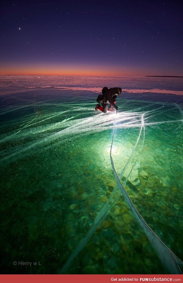 Man with flashlight on ice