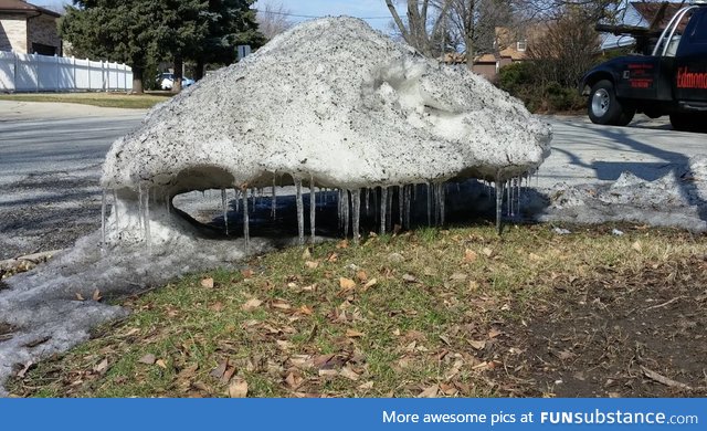 This pile of snow is melting out from under itself