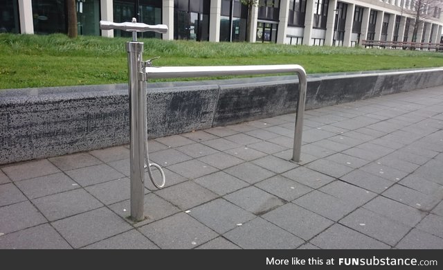 A public bike stand with a built-in pump