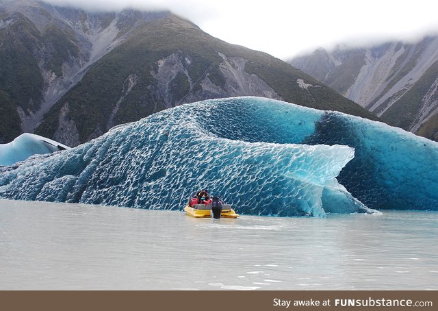 The dark blue bottom of an iceberg that rolled over