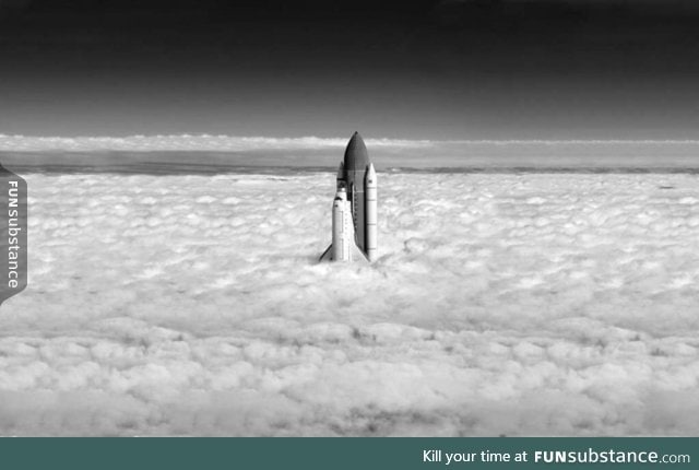 Perfectly timed shot of shuttle exiting the cloud cover