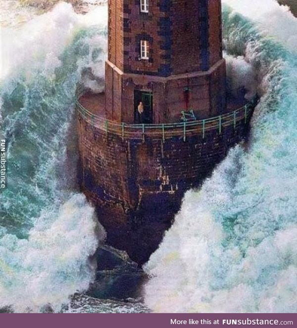 A lighthouse worker surrounded by a storm surge