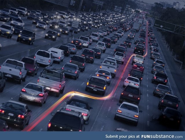 Long exposure of a motorcycle cutting through traffic