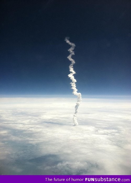 Volcano smoke above clouds