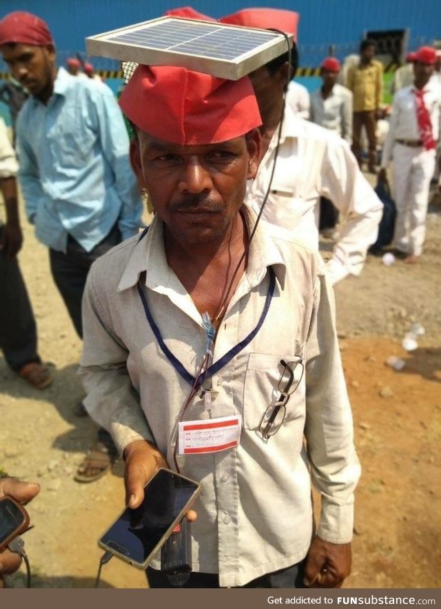 Farmer in India brings along solar panel to charge phones for extra cash