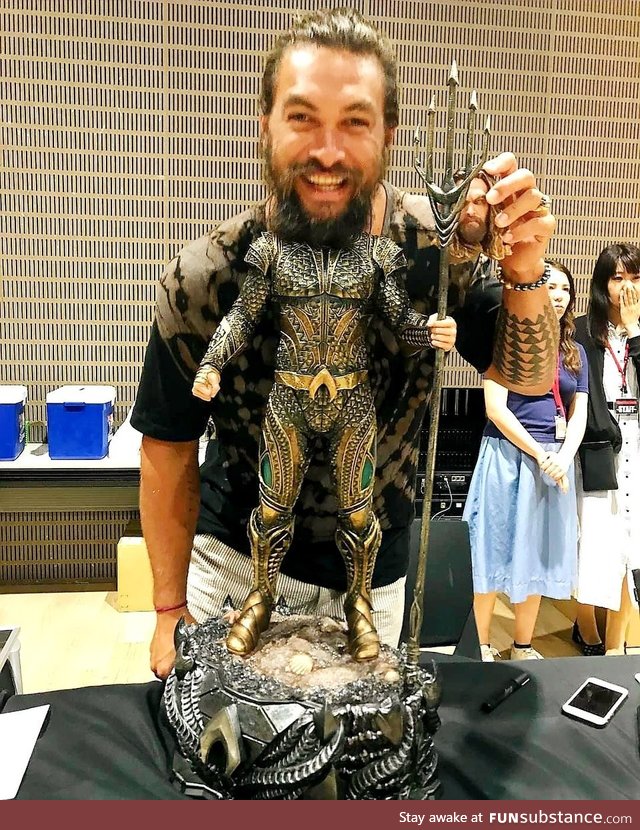 Jason Mamoa having fun with his action figure