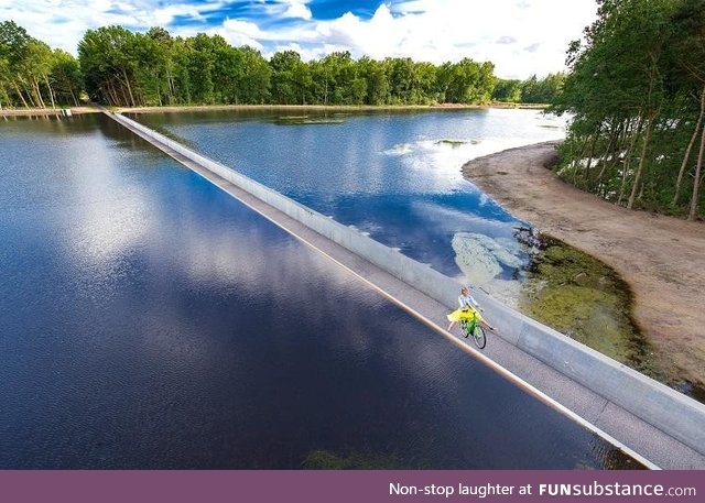 Bike path going through a lake in Limburg, Belgium