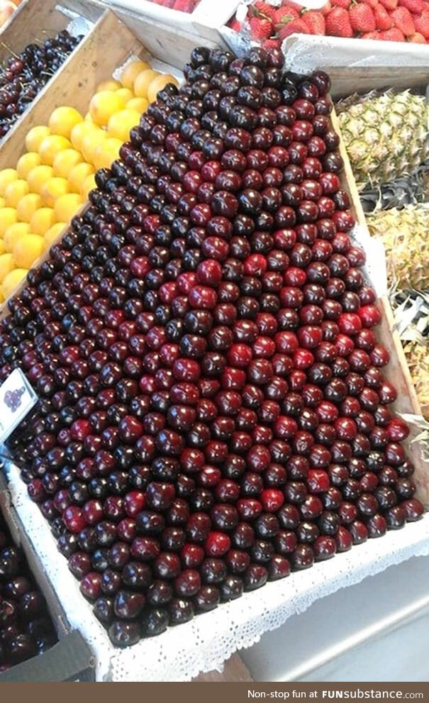 Neatly stacked cherries in market