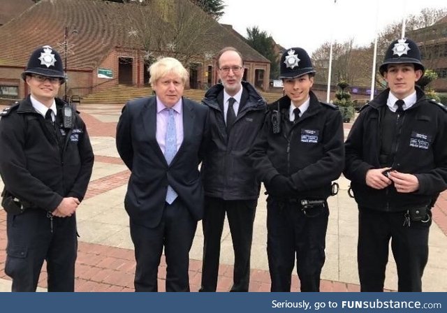 Don’t hold your hands behind your back while taking a photo with police officers