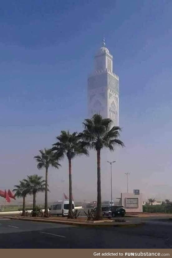 The Hasan ll Mosque in Morocco, the lower part obscured by fog, giving the illusion of it