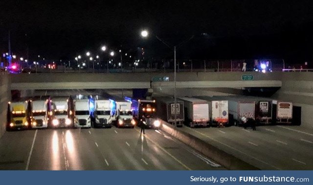 Truckers trying to keep a man from jumping