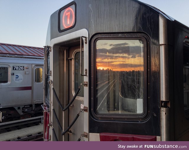 Sunset reflected by a 7 train