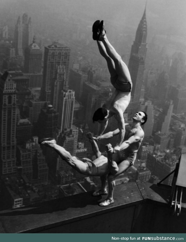 Acrobats balance at the top of Empire State Building, 1934