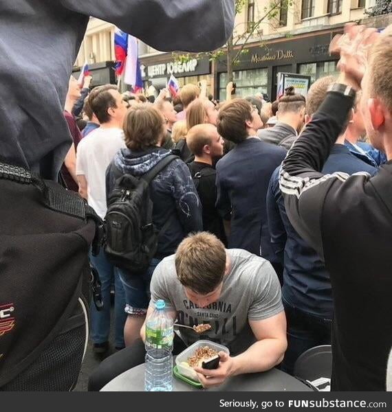 Trying to eat his breakfast in the middle of a protest