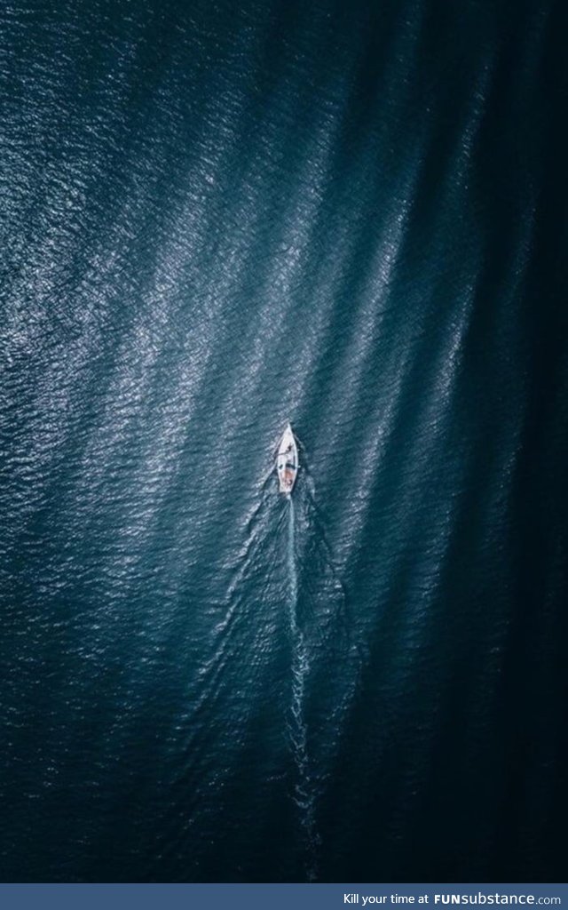 This rip in a leather sofa looks like a boat floating in the open sea