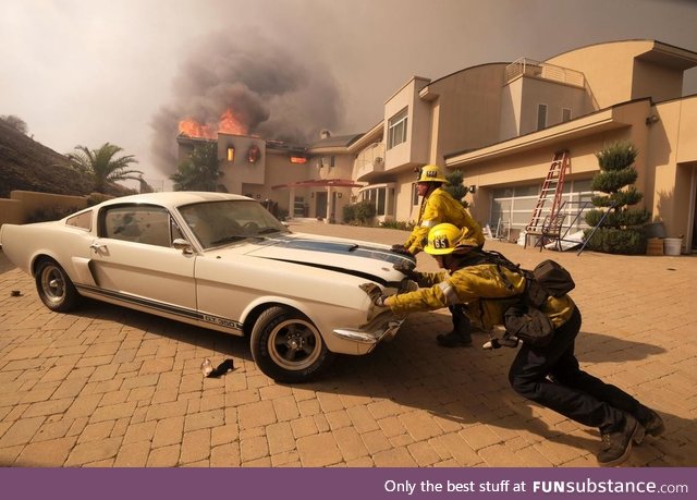 Firefighters saving a classic car from the California wildfires