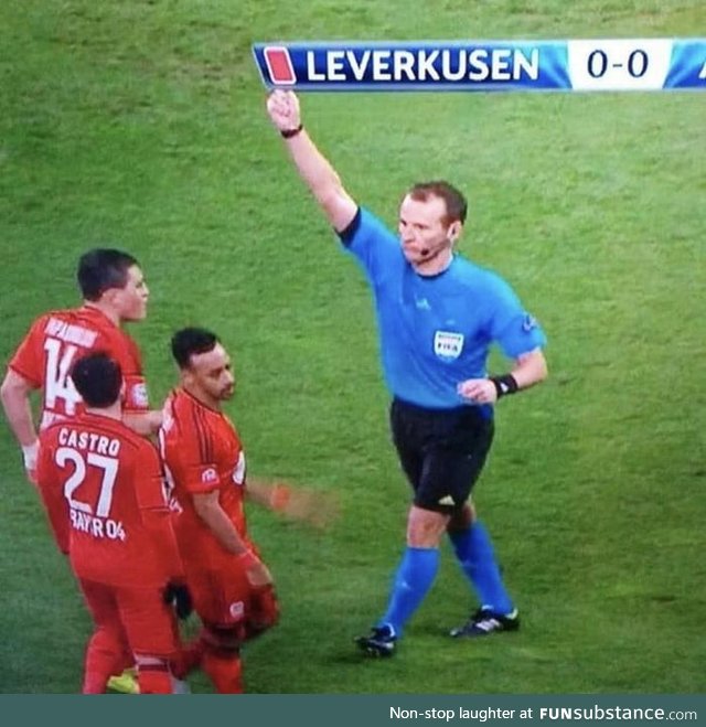 Referee (don't know how to spell it, shut up) holds red card in the perfect position