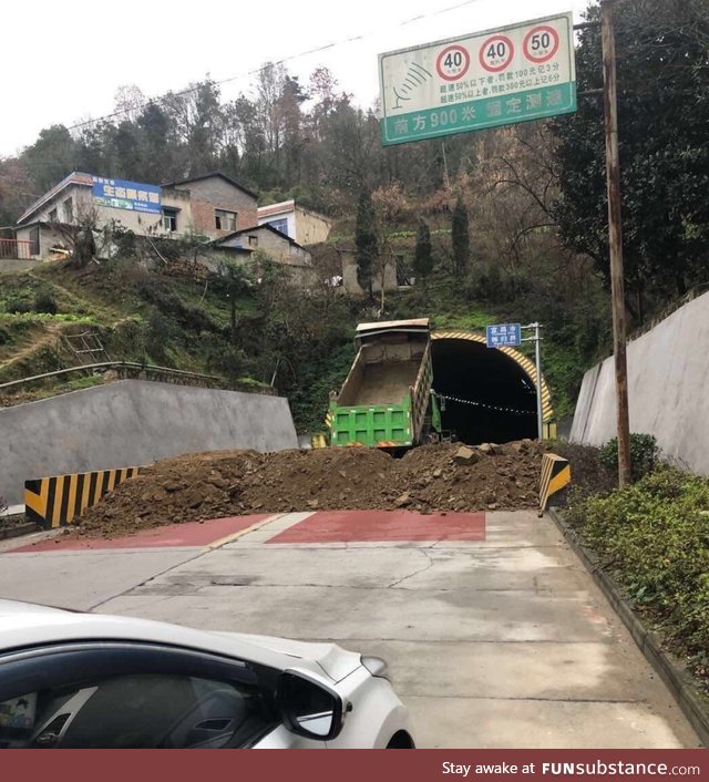 Wuhan, China city officials use dirt to block roads