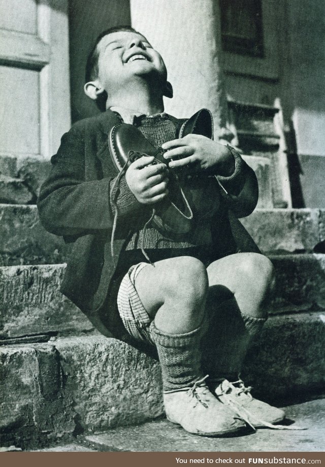 A 6 year-old boy, living in an orphanage in Austria rejoices and hugs a new pair of shoes