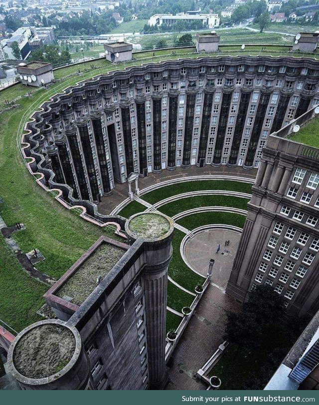 The curved building is Le Théâtre at the Espaces d’Abraxas, a real estate complex