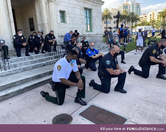 The police taking a knee with protesters in Miami, Florida