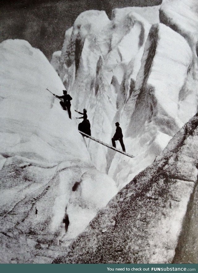 Late Victorian mountaineers cross a crev[ass]e in the Alps, circa 1900