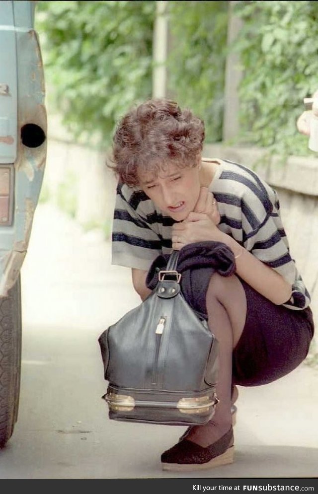 Bosnian Muslim women hides behind a car as Serbian snipers opens fire at her during the