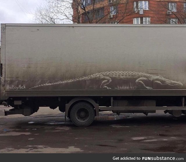 Alligator drawn into dirt on side of a truck