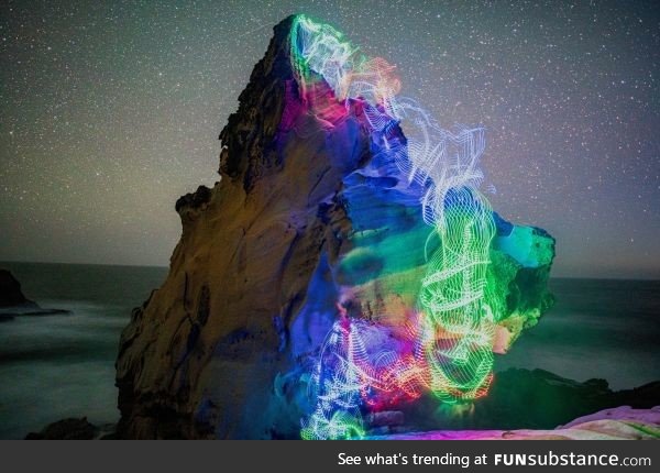 Long exposure I took of myself bouldering on the ocean with LEDs tied to myself