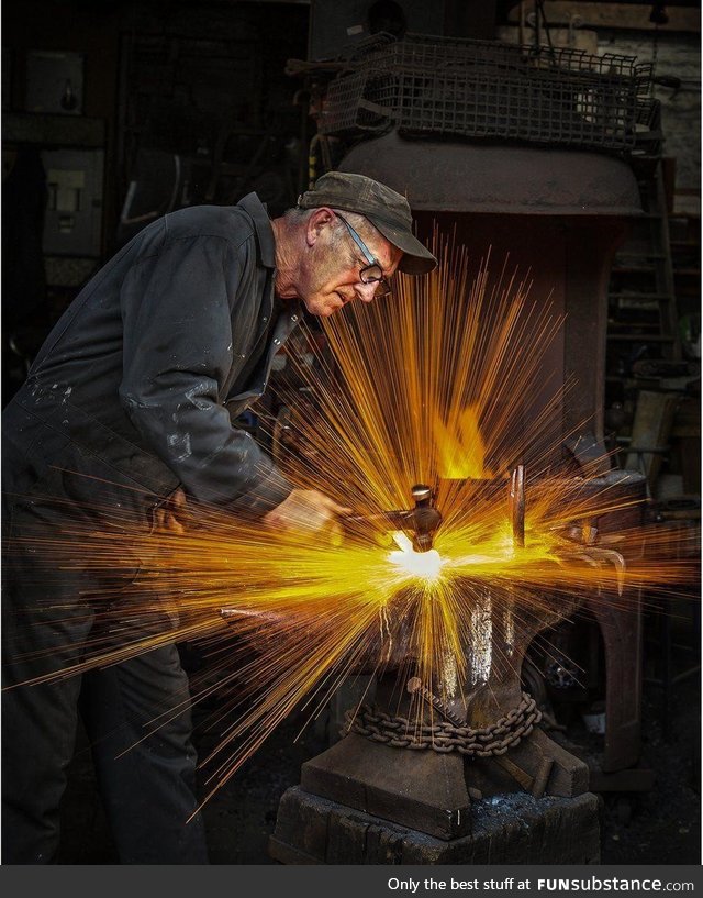 Blacksmith striking his hammer