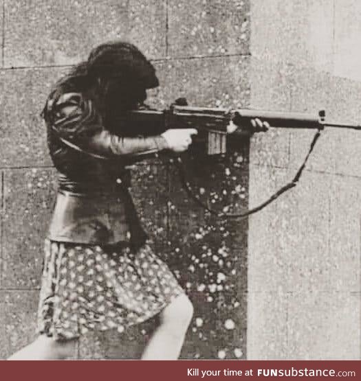 This photograph taken in Ireland in 1972 of a girl shooting from the gun of her fiancé