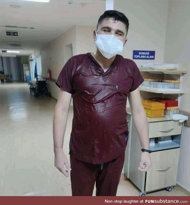 A nurse takes off his protective suit after a 36 hour covid shift