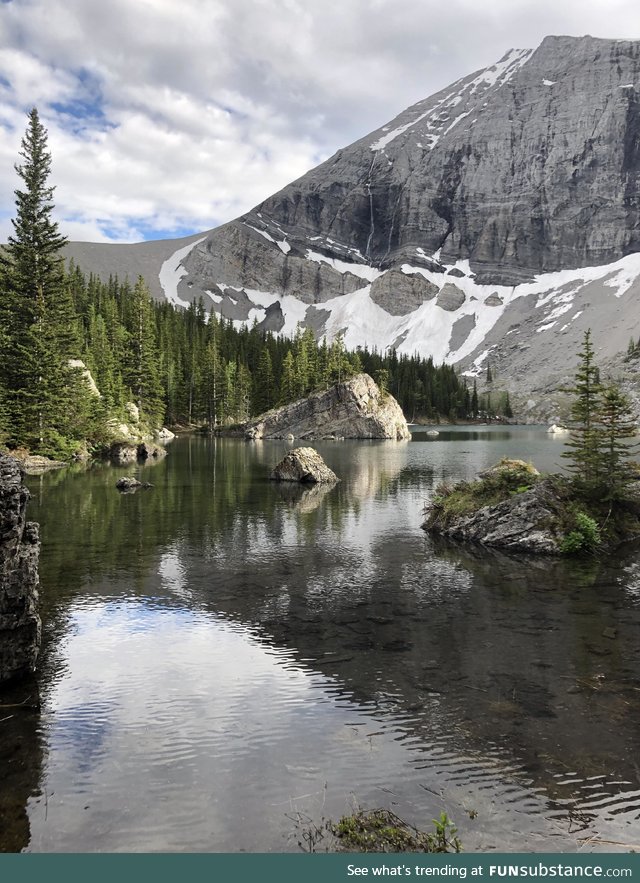 A river running by a mountain in the Canadian Rockies