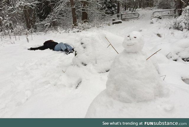 I built a low-effort snowman while my girlfriend lay down in the snow. It kind of ended