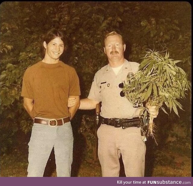 Man proposes to other man with bouquet of weed flowers, 1969