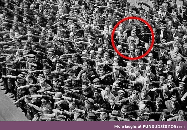 Man brings a red hula hoop to a Nazi Rally in Berlin,