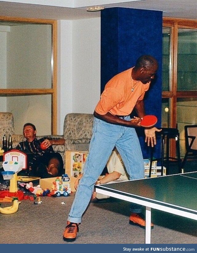 Michael Jordan plays ping pong while Larry Bird gets drunk, taken during the 92 Olympics