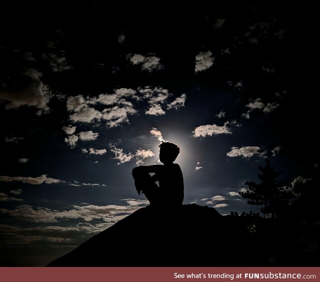 Boy on rock in moonlight