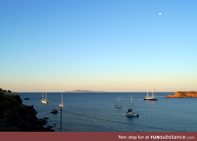 Sunrise light and moonset over the Aegean Sea in Greece