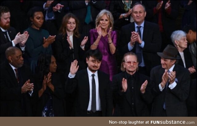 Brandon Tsay, the man who disarmed the Calif., gunman, sits near Bono and Dr. Jill Biden